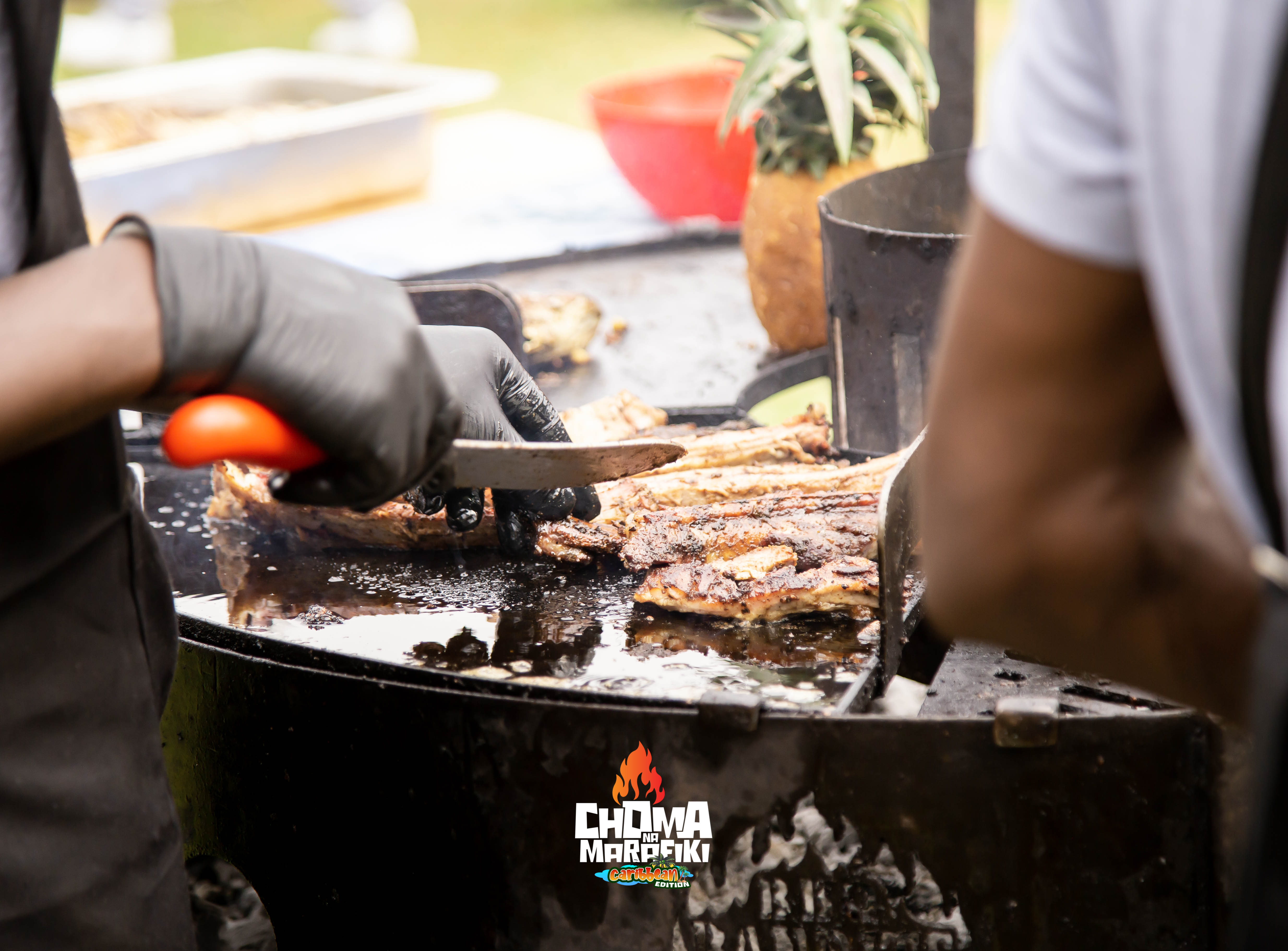 Grillmaster carving BBQ meat at Choma Na Marafiki Caribbean Edition