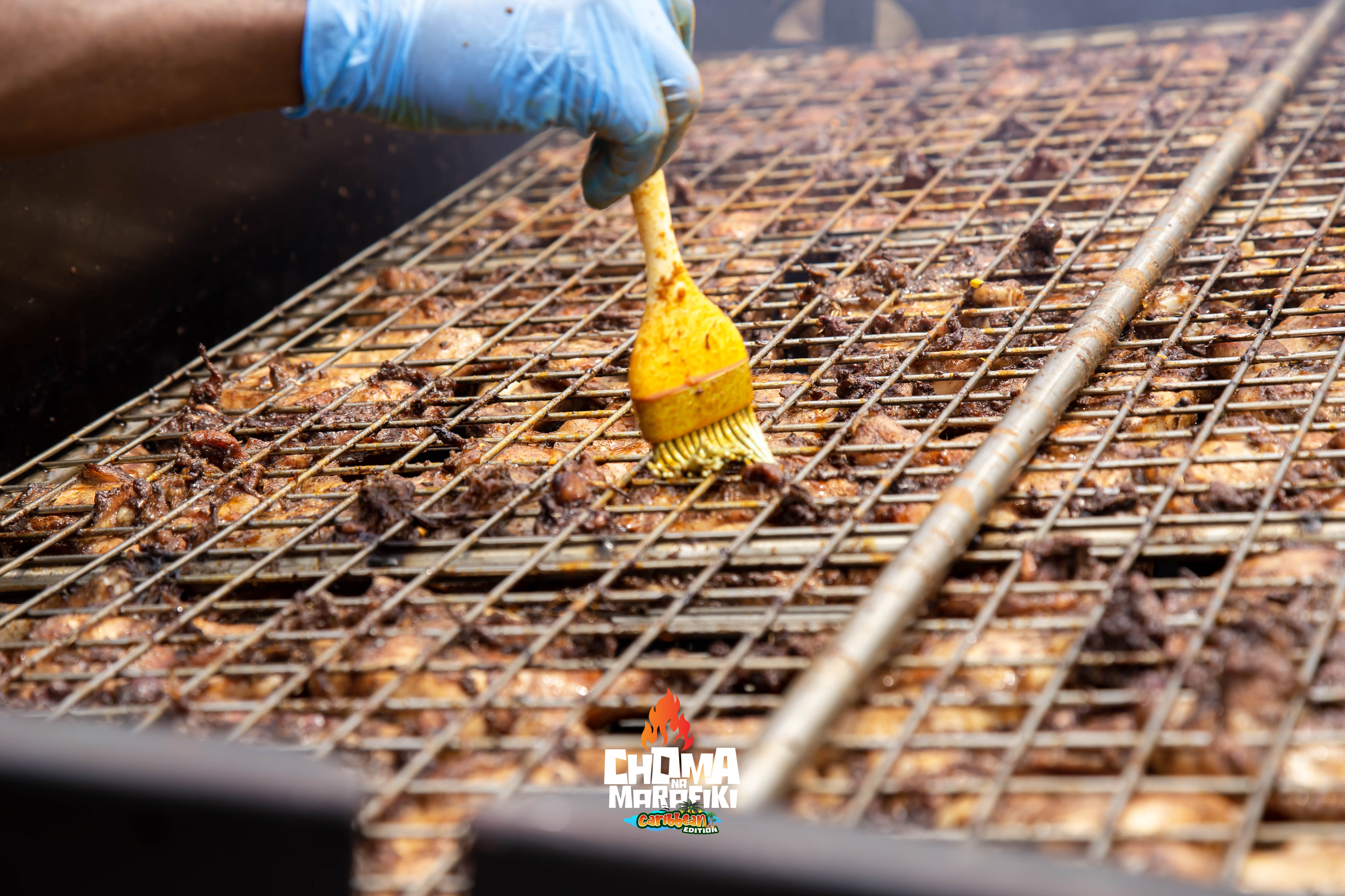 Large BBQ smoker packed with ribs and chicken at Choma Na Marafiki