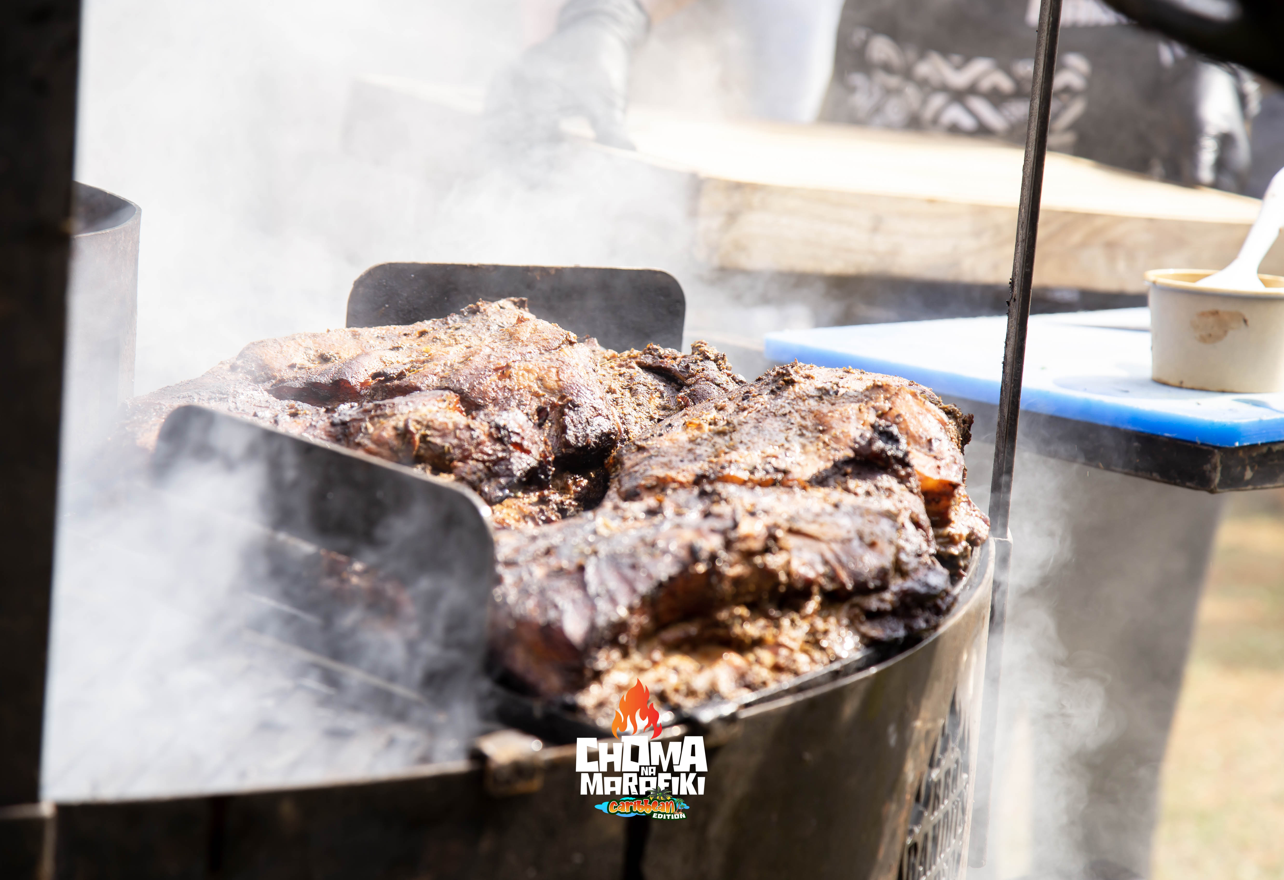BBQ ribs smoking on the open barrel grill with pineapple