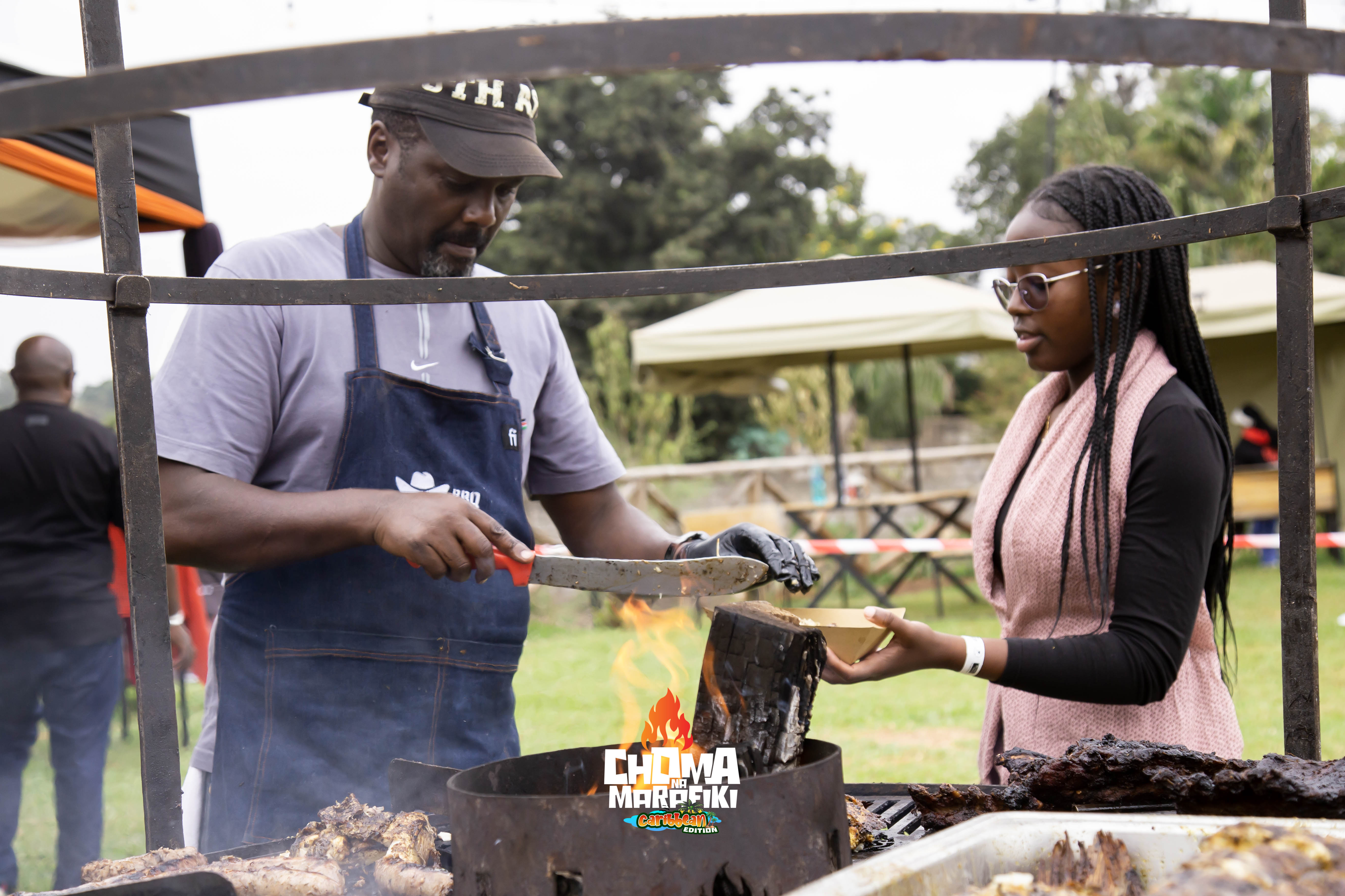 Grillmaster serving freshly carved BBQ meat to a guest