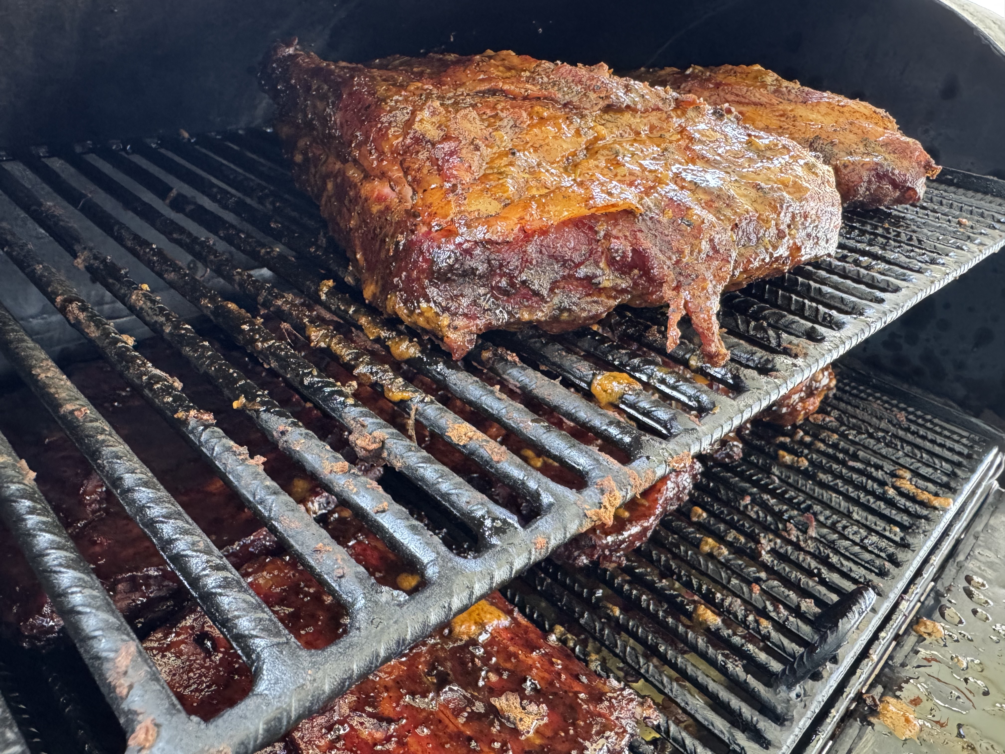 Premium cuts slow-cooking on the BBQ smoker